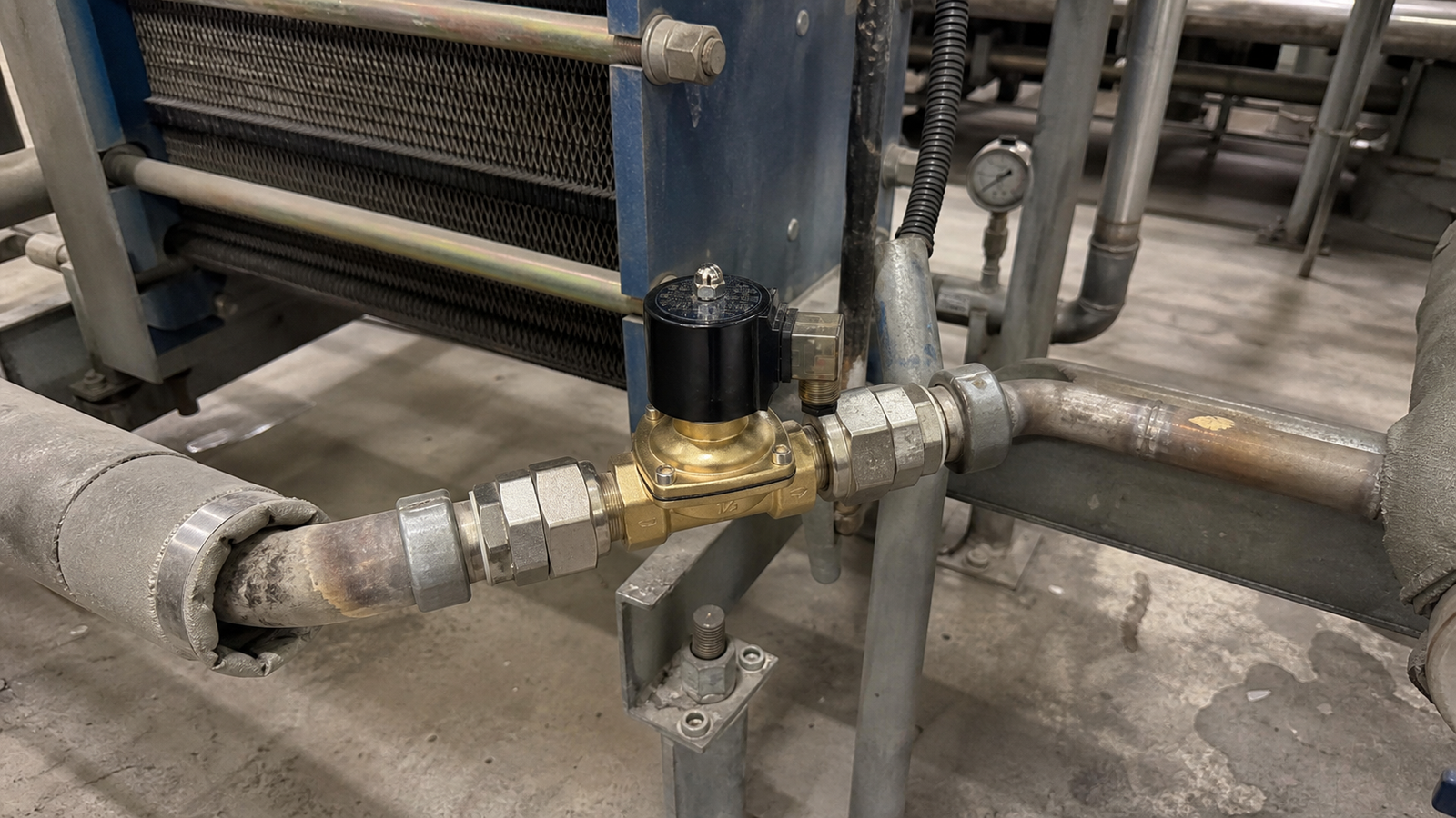 Industrial solenoid valve installation in a processing environment with automated flow control
